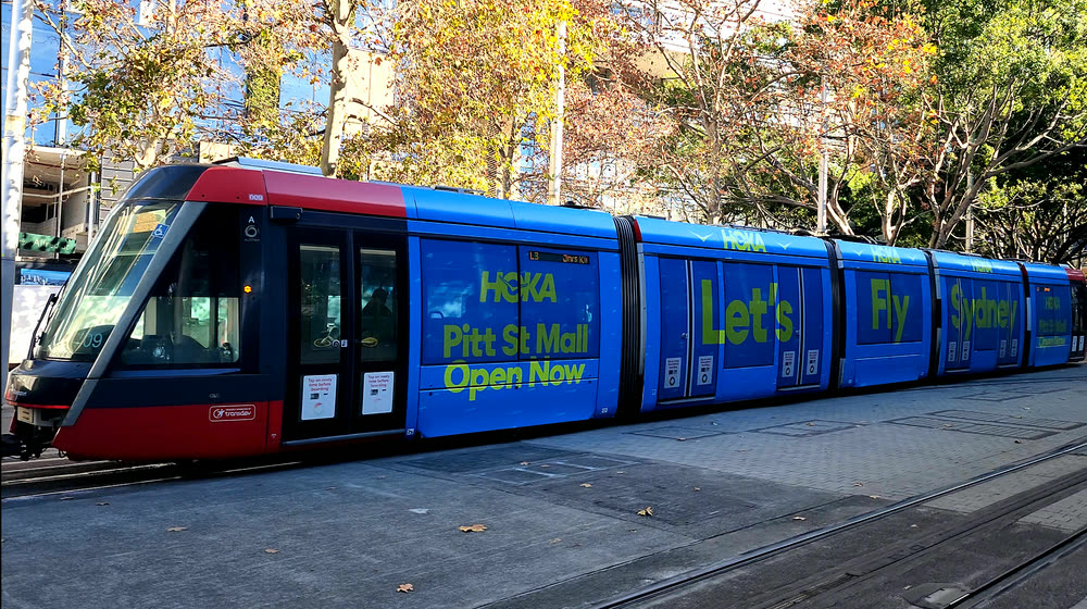 Sydney Light Rail tram in full-body advertising livery on George Street