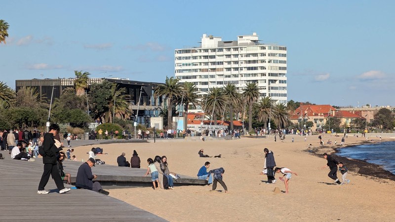 St Kilda Beach in Melbourne crowded with people along the foreshore boardwalk