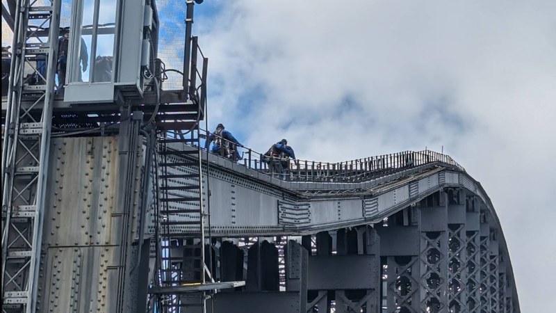 Climbers roped to the upper arch of the Sydney Harbour Bridge on the BridgeClimb