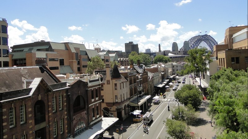 The Rocks in Sydney from above, with the Harbour Bridge arch behind the historic streets